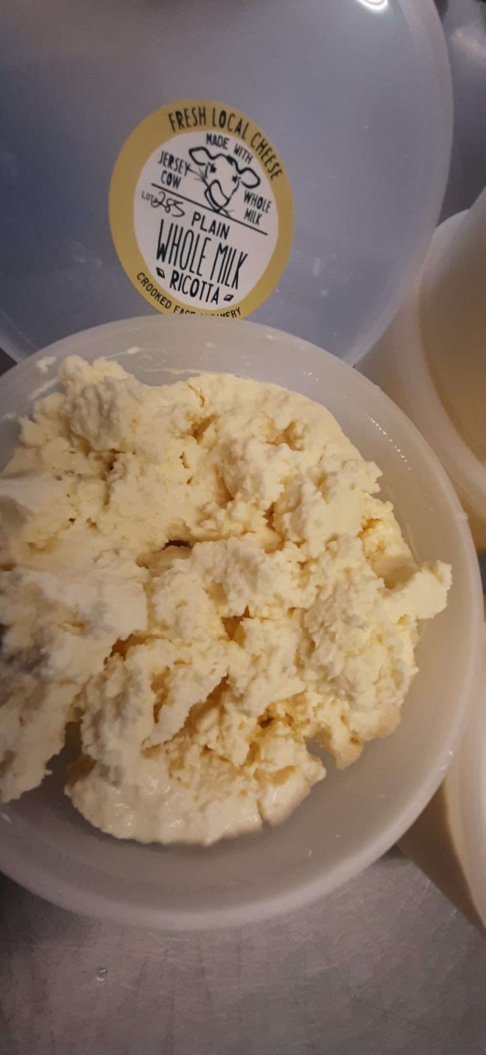 Fresh whole milk ricotta in a tub