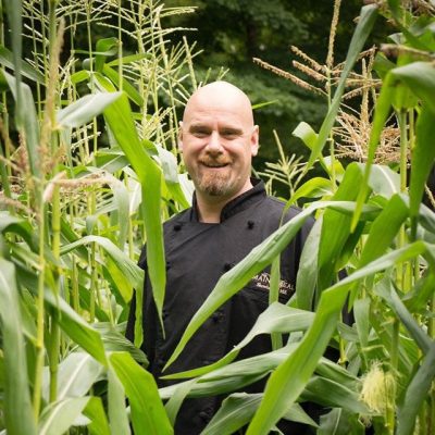 Chef Mark standing in a Maine cornfield